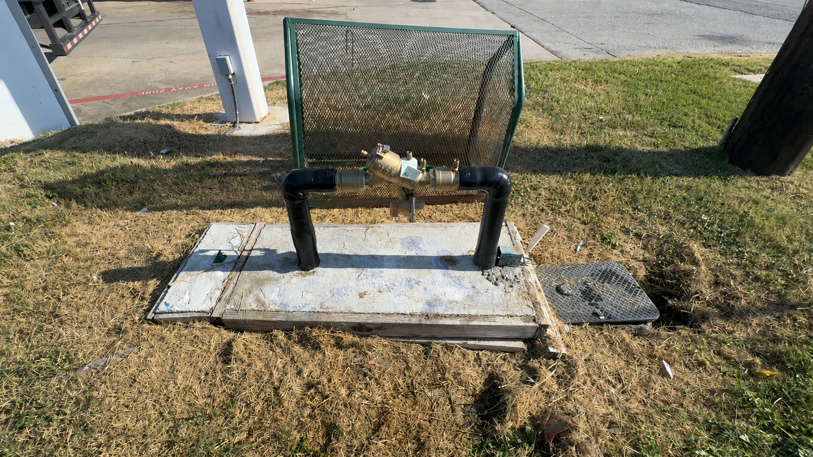 Certified backflow tester inspecting a residential backflow preventer